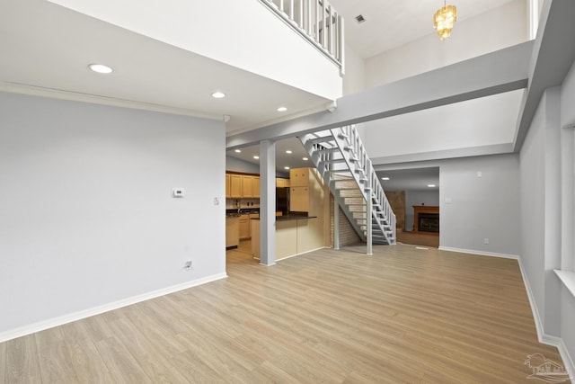 204 Camelia St, Gulf Breeze, FL 32561 - unfurnished living room featuring a fireplace, recessed lighting, stairway, light wood finished floors, and baseboards