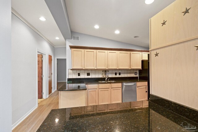 204 Camelia St, Gulf Breeze, FL 32561 - kitchen with stainless steel dishwasher, a sink, light brown cabinets, backsplash, and lofted ceiling