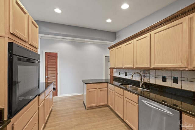 204 Camelia St, Gulf Breeze, FL 32561 - kitchen with stainless steel dishwasher, a sink, oven, light brown cabinets, and tasteful backsplash