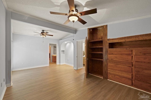 204 Camelia St, Gulf Breeze, FL 32561 - spare room featuring a ceiling fan, light wood finished floors, arched walkways, baseboards, and a textured ceiling
