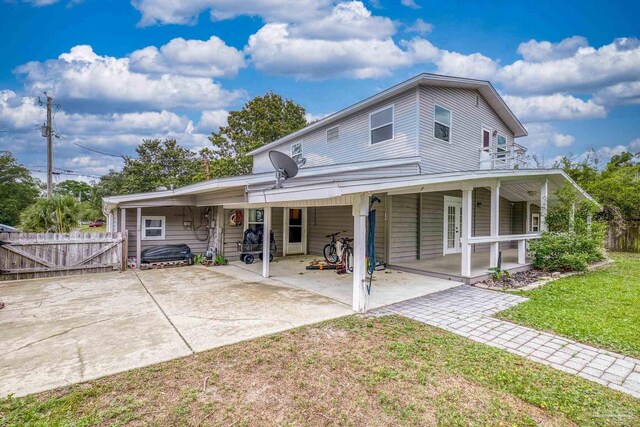 204 Camelia St, Gulf Breeze, FL 32561 - rear view of property featuring a gate and covered porch