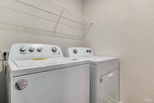 laundry room featuring washing machine and clothes dryer