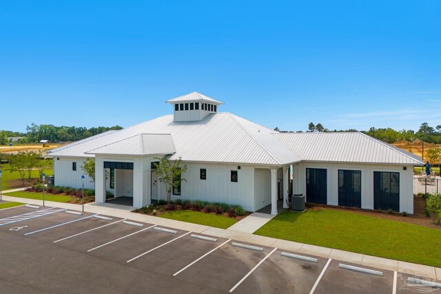 view of building exterior featuring a carport and central AC