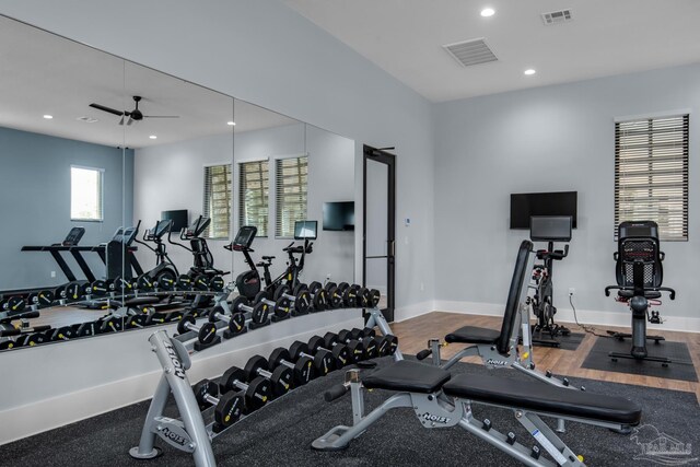 gym with hardwood / wood-style floors and ceiling fan