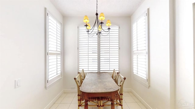 tiled dining space featuring an inviting chandelier