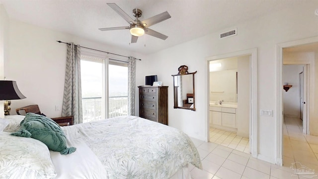 bedroom featuring light tile patterned floors, ceiling fan, and ensuite bathroom