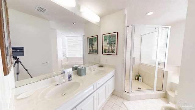 bathroom with vanity, plus walk in shower, and tile patterned flooring