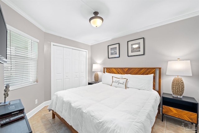 bedroom with light tile patterned floors, baseboards, multiple windows, a closet, and crown molding