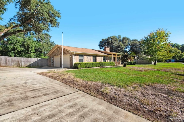 single story home with a garage and a front yard