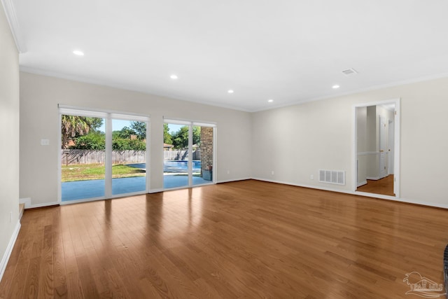 unfurnished room featuring hardwood / wood-style floors and ornamental molding