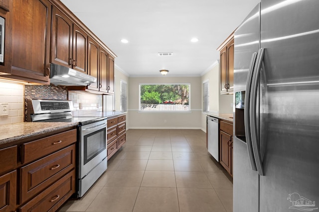 kitchen featuring decorative backsplash, light tile patterned flooring, stainless steel appliances, and ornamental molding