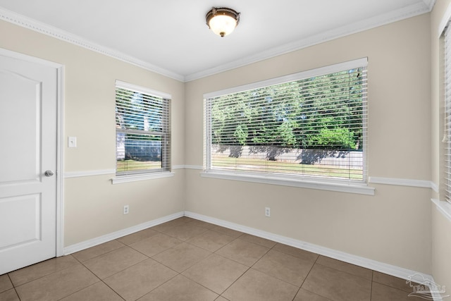 tiled spare room featuring a wealth of natural light and crown molding