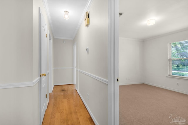 hall featuring light hardwood / wood-style floors and ornamental molding