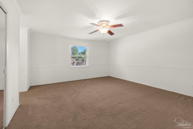 carpeted empty room with ceiling fan and crown molding