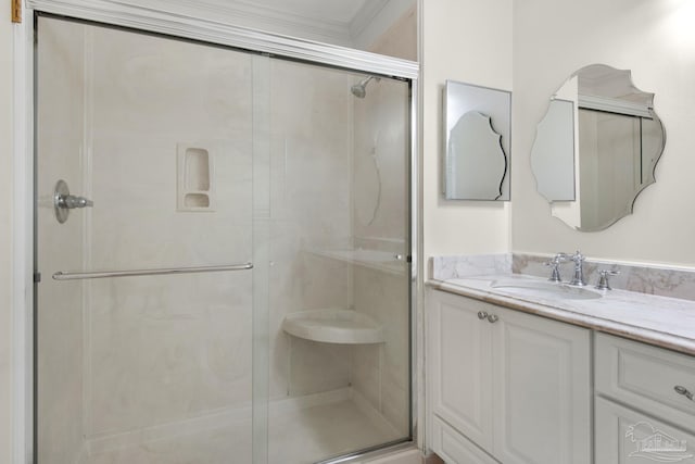 bathroom with vanity, walk in shower, and ornamental molding