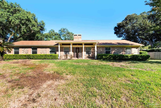 ranch-style home with a front lawn