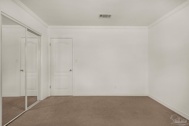 unfurnished bedroom featuring carpet flooring, a closet, and ornamental molding