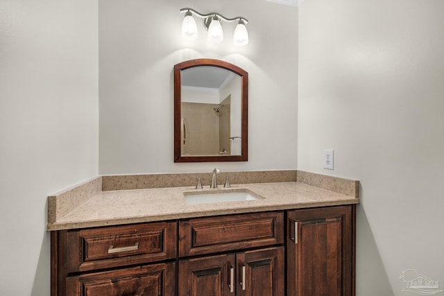 bathroom with crown molding and vanity