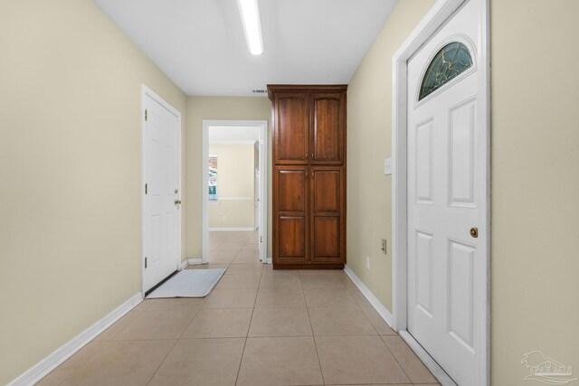 hall featuring light tile patterned floors