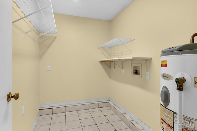 washroom with water heater, light tile patterned floors, and washer hookup