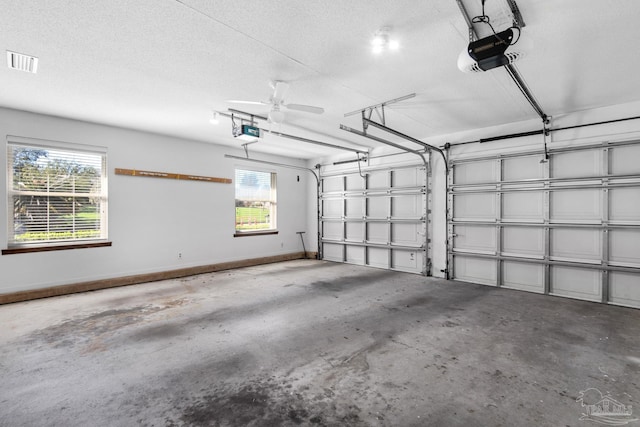 garage with ceiling fan and a garage door opener