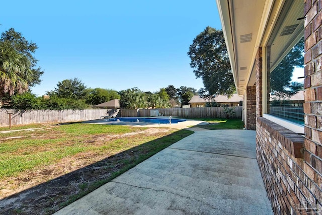 view of yard featuring a fenced in pool and a patio