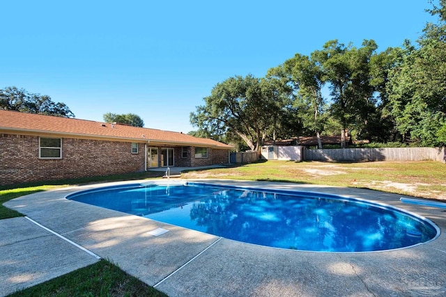 view of pool with a yard