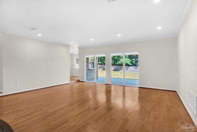 unfurnished living room featuring light hardwood / wood-style flooring and ornamental molding