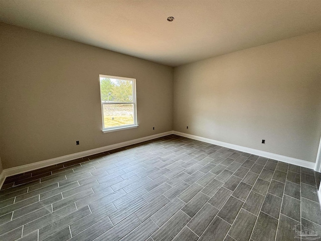 empty room featuring wood finish floors and baseboards