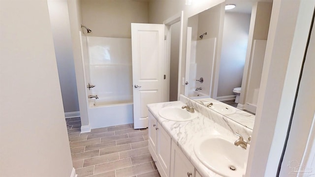 full bath featuring a sink, shower / tub combination, and double vanity