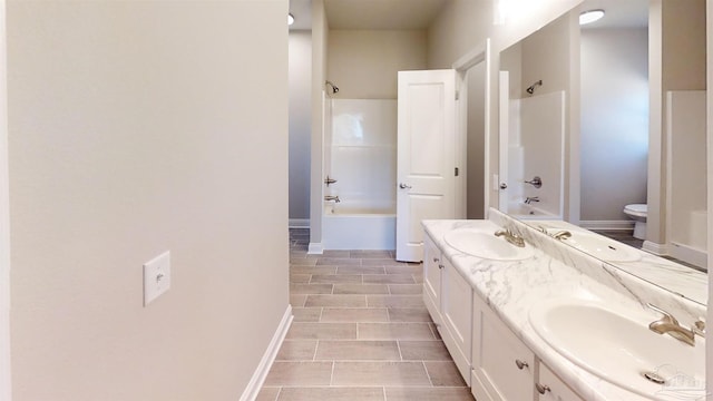 full bathroom featuring double vanity, shower / bath combination, and a sink