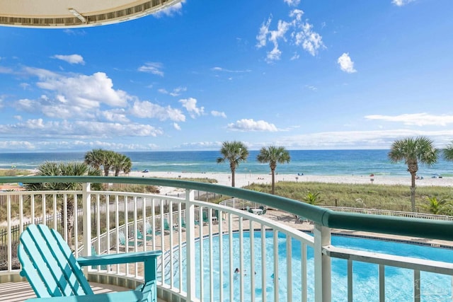 balcony with a beach view and a water view