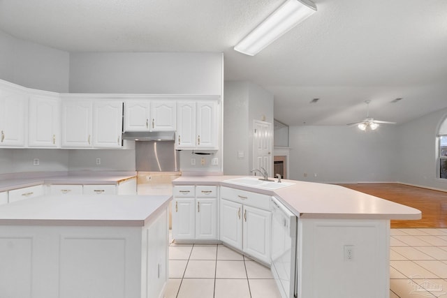 kitchen with dishwasher, a center island, sink, and white cabinets