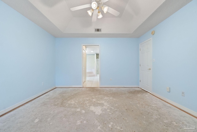 unfurnished room with a raised ceiling and ceiling fan