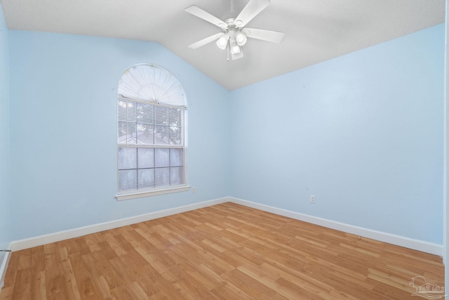 empty room featuring ceiling fan, lofted ceiling, and light wood-type flooring