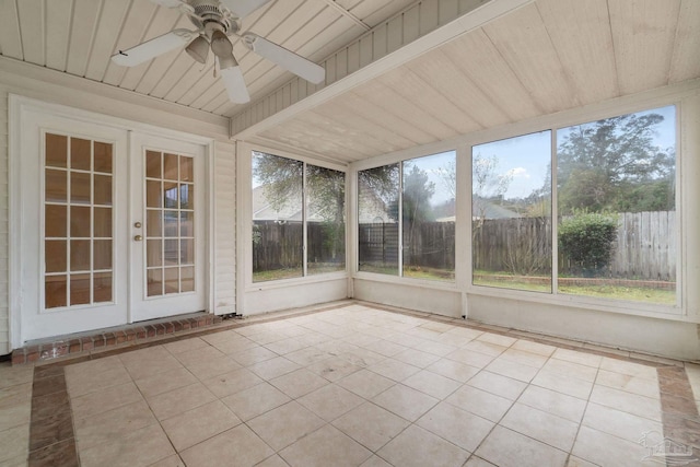 unfurnished sunroom featuring wood ceiling and ceiling fan