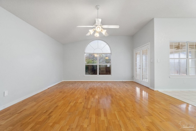 unfurnished room featuring ceiling fan, lofted ceiling, and light wood-type flooring