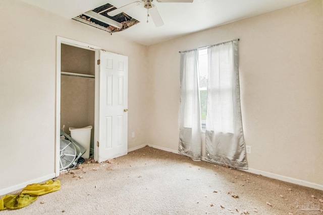 unfurnished bedroom with ceiling fan, carpet, and baseboards