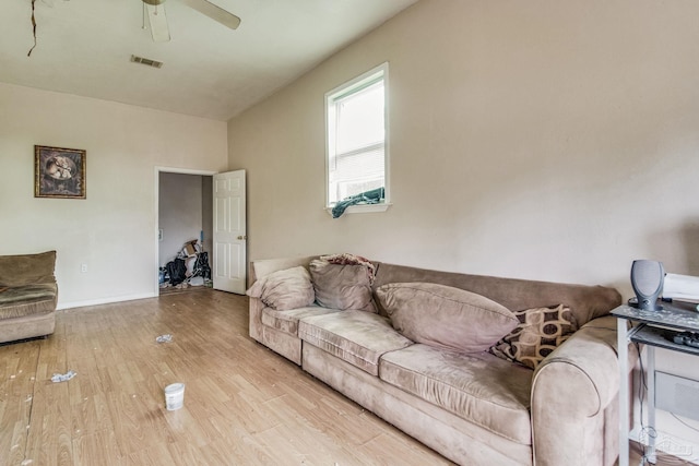 living room with light wood-type flooring and ceiling fan