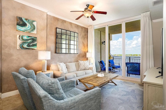 living room with ceiling fan and ornamental molding