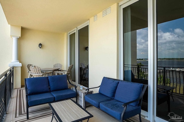 balcony featuring a water view