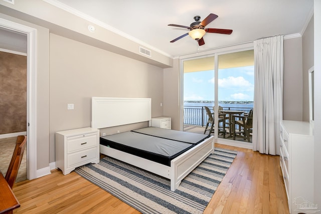 bedroom with light hardwood / wood-style floors, access to exterior, and ornamental molding