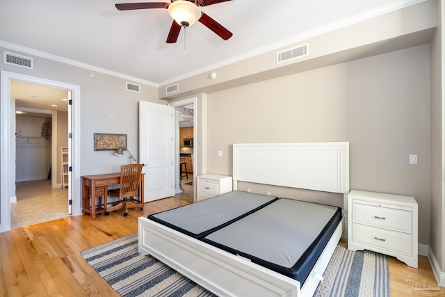 bedroom featuring ceiling fan, light hardwood / wood-style flooring, and crown molding