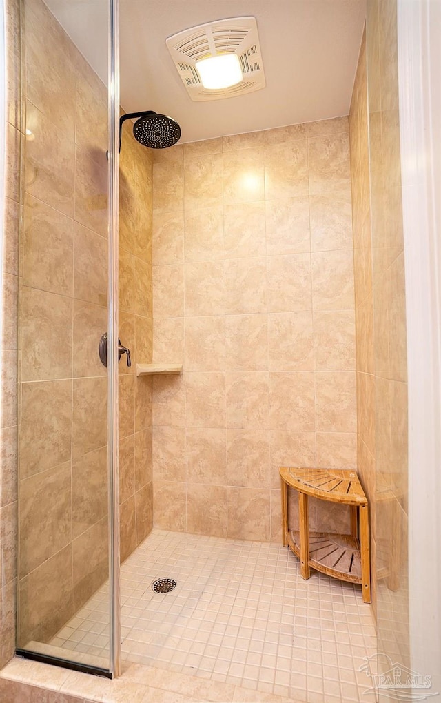 bathroom with a tile shower