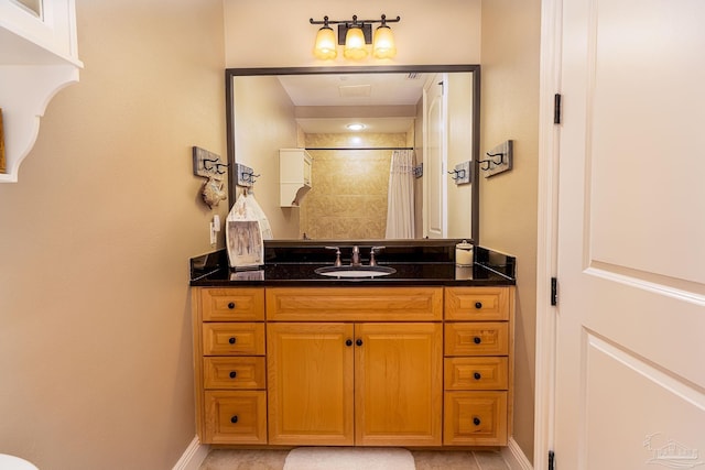 bathroom featuring curtained shower and vanity