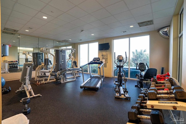 gym with a paneled ceiling