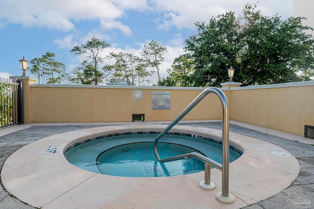 view of pool with a hot tub