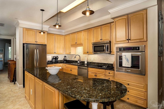 kitchen featuring decorative light fixtures, sink, tasteful backsplash, dark stone countertops, and stainless steel appliances