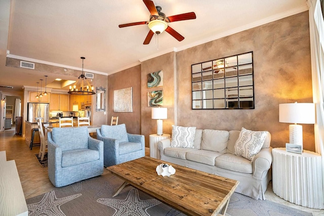 living room featuring tile patterned floors, ceiling fan with notable chandelier, and crown molding