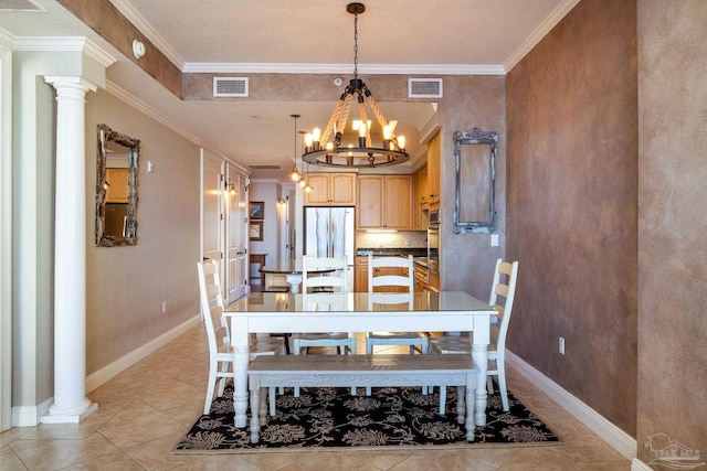 tiled dining area featuring ornate columns, crown molding, and a notable chandelier